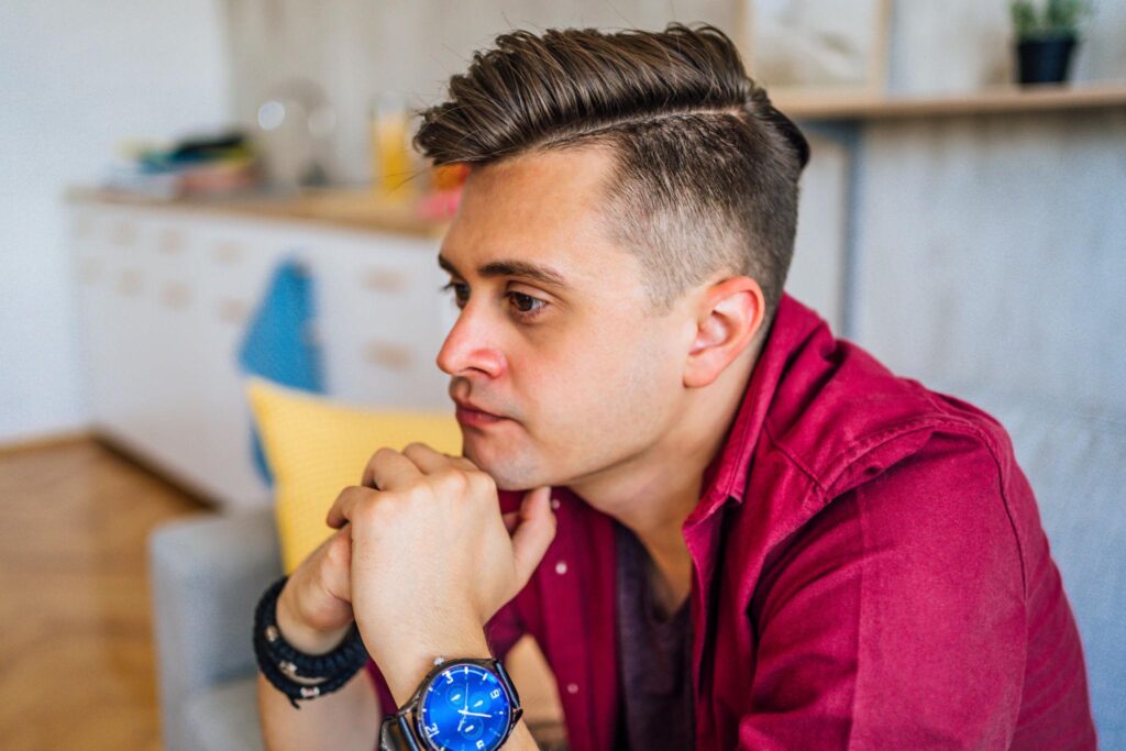Person sitting quietly in reflection seeking guidance for life challenges and emotional support
