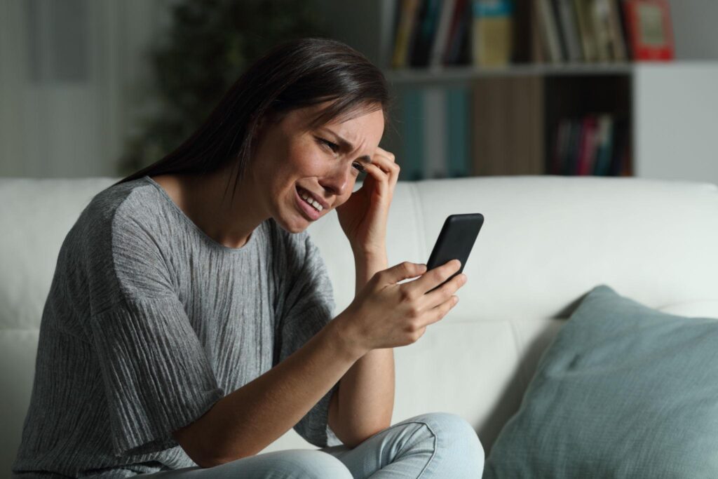 Person feeling emotional after breakup waiting for message from lost lover