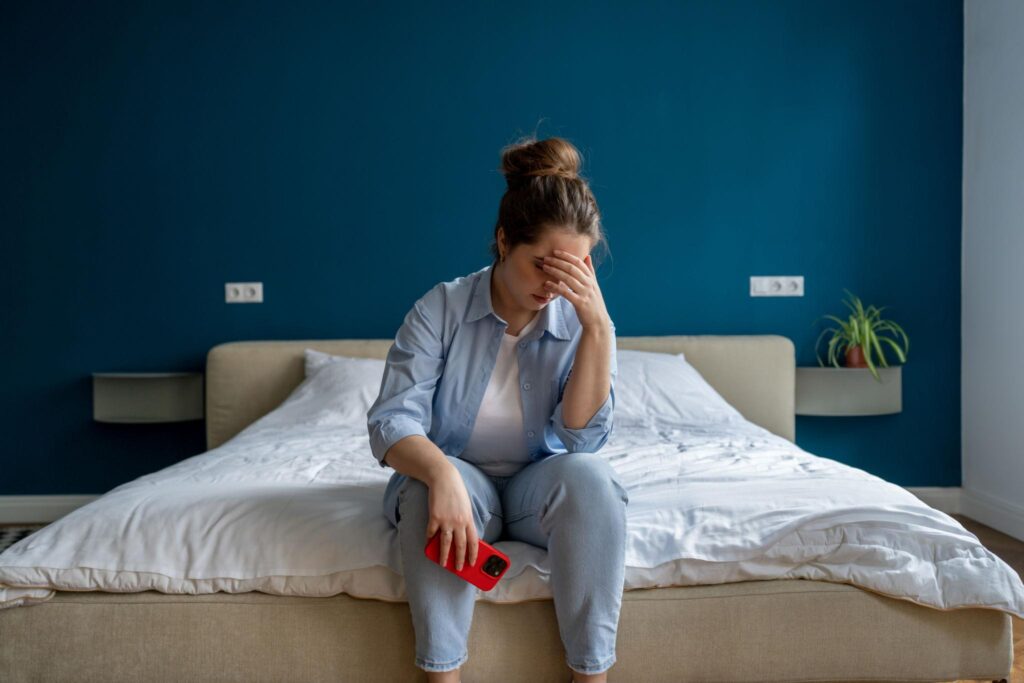 Person feeling emotional after breakup waiting for message from lost lover