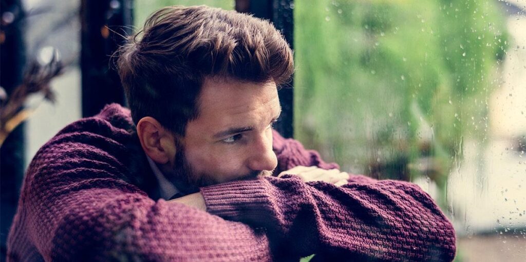 Person feeling emotional after breakup waiting for message from lost lover