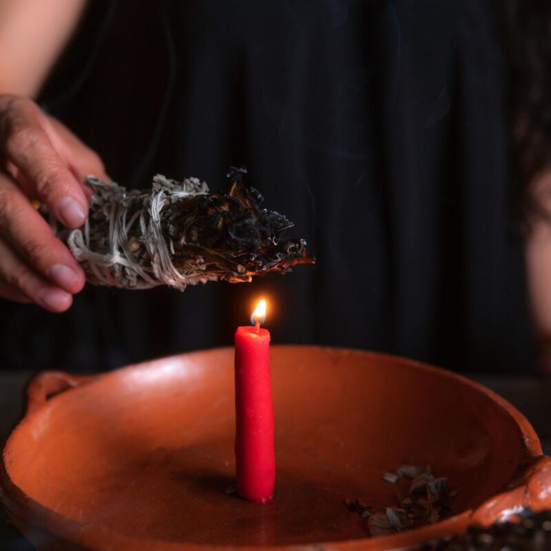 traditional healer performing cleansing ritual to remove financial blocks