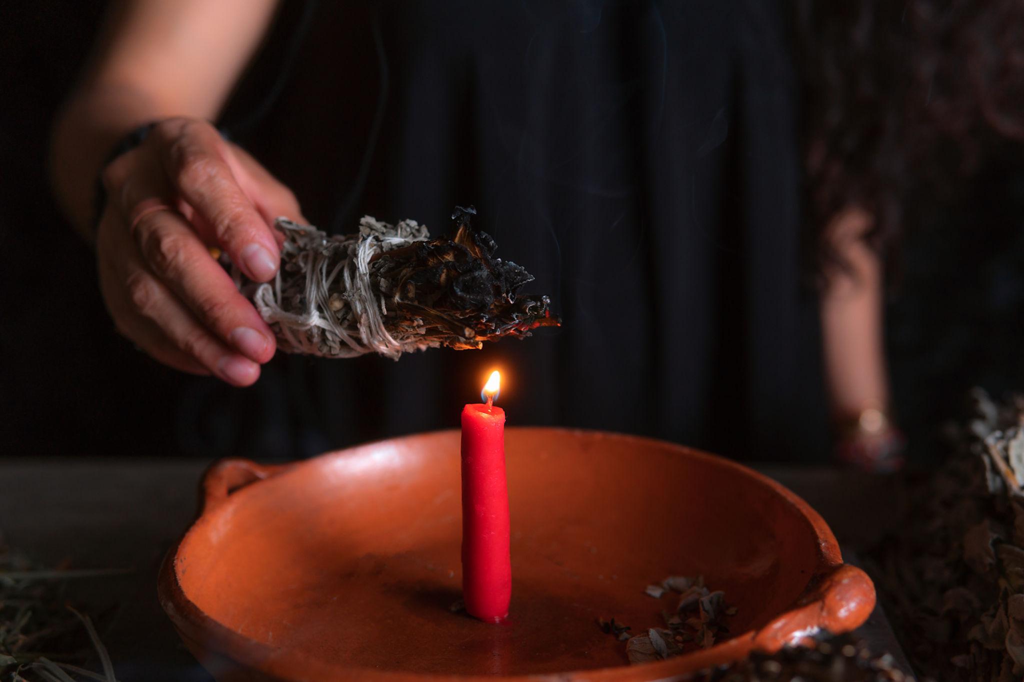 traditional healer performing cleansing ritual to remove financial blocks