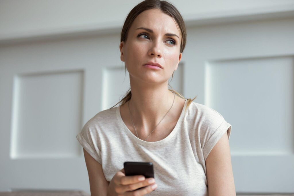 Woman waiting for message feeling emotional in relationship