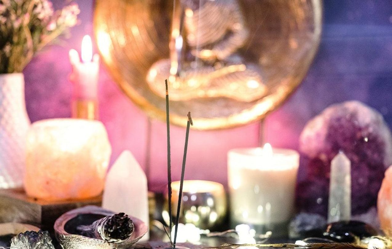 Spiritual Healing Setup with Candles and Herbs